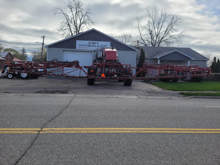 Red tractor at K&H Hydraulics offering hydraulic repair
